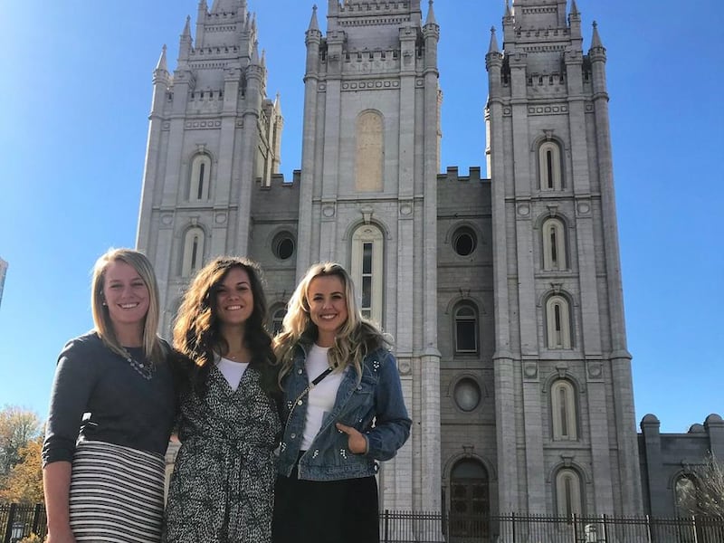 Morgan Jones (middle) smiles for a photo in front of the Salt Lake Temple with friends McKenzie Gummersall and Chelsie Hightower following a temple worker devotional.