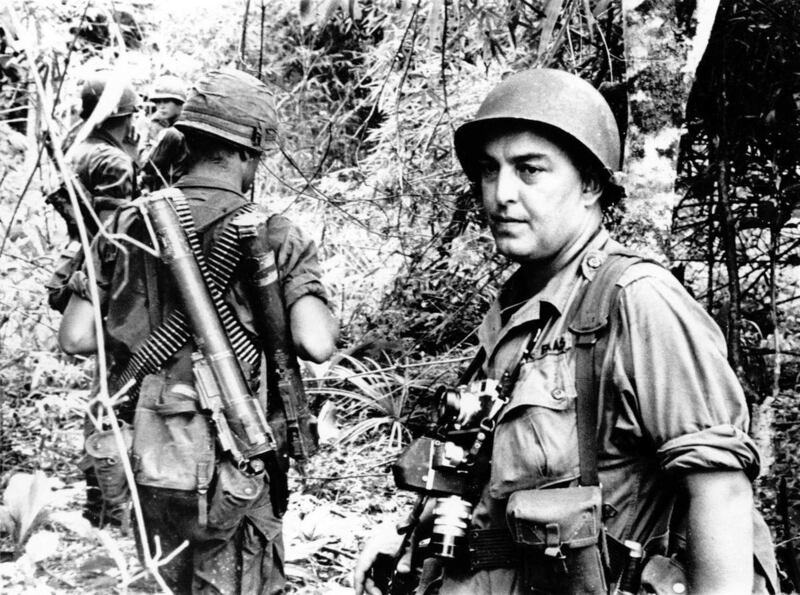 FILE - In this undated file photo, Associated Press photographer Horst Faas is shown on assignment with soldiers in South Vietnam. Faas, a prize-winning combat photographer who carved out new standards for covering war with a camera and became one of the