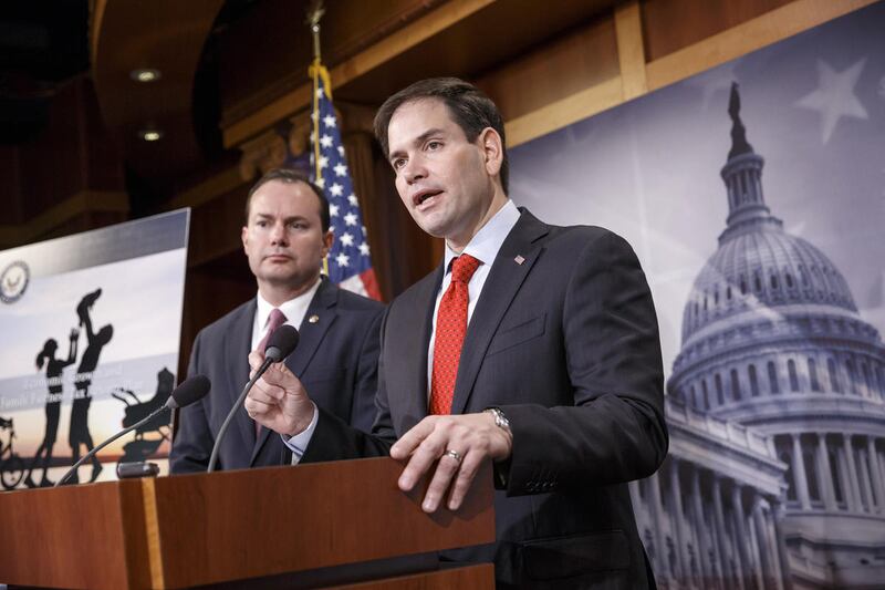 FILE - Sen. Marco Rubio, R-Fla., right, accompanied by Sen. Mike Lee, R-Utah, outline their ideas for a new tax plan during a news conference on Capitol Hill in Washington, Wednesday, March 4, 2015. Doubling the child tax credit is key to Sen. Mike Lee go