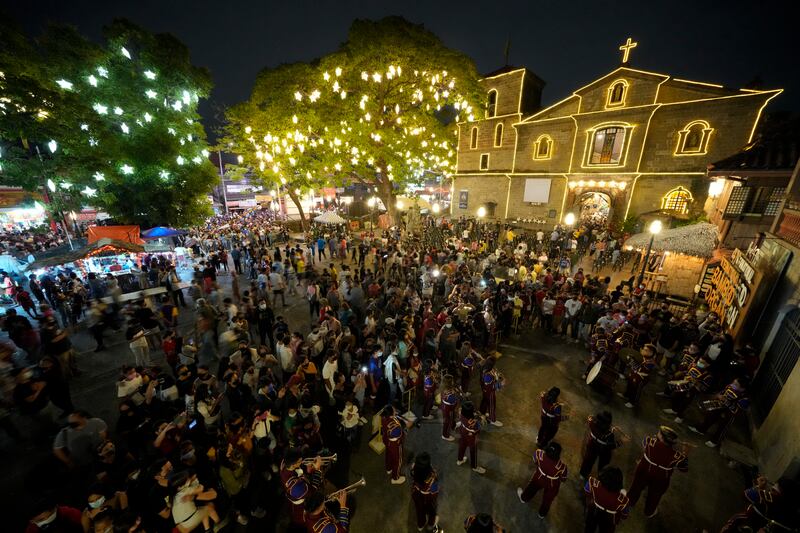 People attend the first of nine daily dawn masses before Christmas at the St. Joseph Parish Church in suburban Las Pinas city, Philippines.