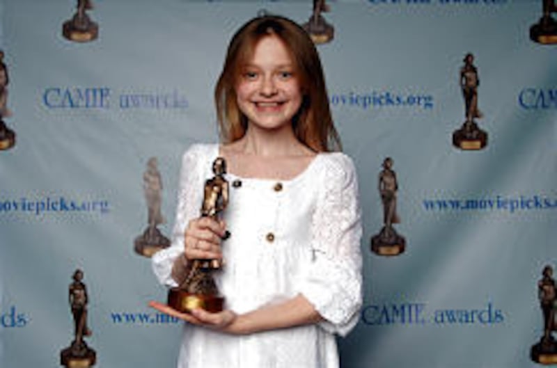 Dakota Fanning accepts an award at the fifth annual CAMIE Awards recently in North Hollywood.