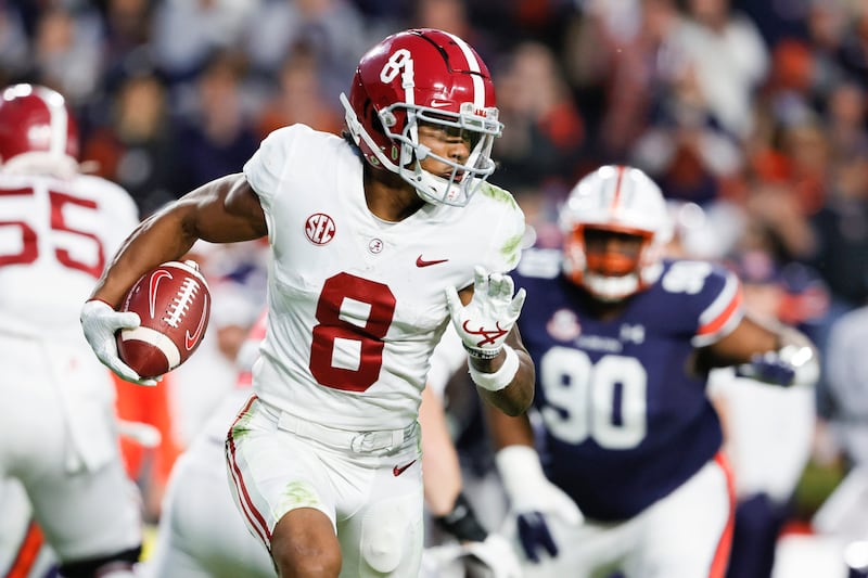 Alabama wide receiver John Metchie III carries the ball during a game against Auburn on Nov. 27, 2021.