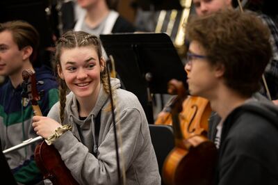 Emile Peele, center, and orchestra members practice with Thierry Fischer, music director of the Utah Symphony, at Cottonwood High School in Murray on Thursday, March 14, 2019. High school orchestras across the state are rehearsing the same piece and will
