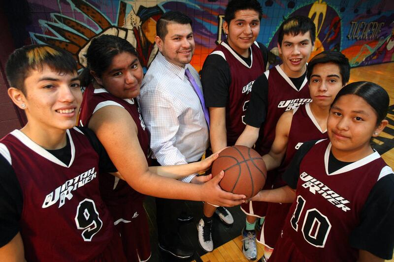 The Uintah River High School Warriors won their first Utah School Sports Association basketball title Saturday, defeating Wasatch Academy by a score of 74-57. The Warriors, from left, are: Guliano Serawop, Tiger Taveapont, head coach David Sorensen, Tre T