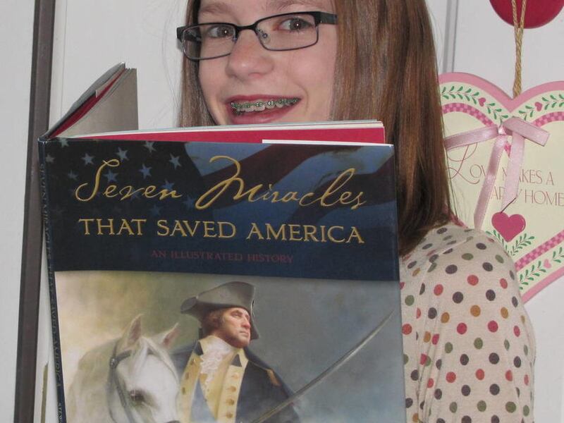 Ellie De Groote holds "Seven Miracles That Saved America."