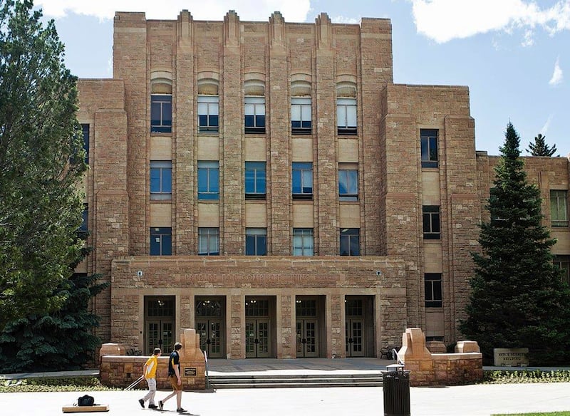 In this 2016 file photo, two people walk on the University of Wyoming campus in Laramie, Wyo.