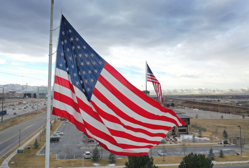 An American flag flies on a cloudy day.