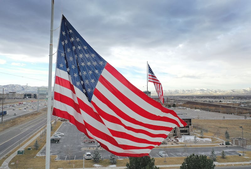 An American flag flies on a cloudy day.