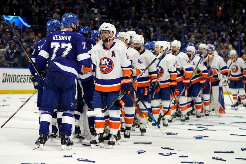 Tampa Bay Lightning defenseman Victor Hedman (77) and his teammates shake hands with New York Islanders right wing Josh Bailey, front right, and his teammates after Game 7 of an NHL hockey Stanley Cup semifinal playoff series Friday, June 25, 2021, in Tampa, Fla. Tampa won the final game 1-0. (AP Photo/Chris O'Meara)