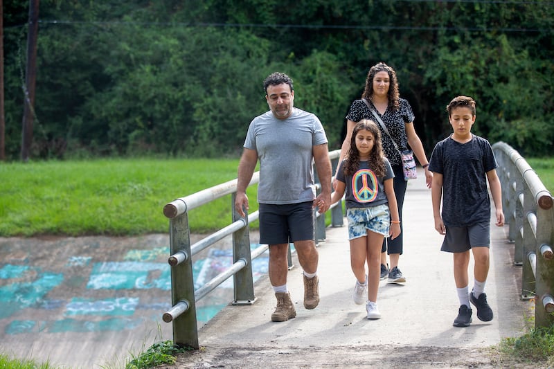 Mohammed Ghanayem walks with daughter Zayna Ghanayem, 9, wife Layla Kaiksow and son Nishan Ghanayem in Kingwood, Texas.