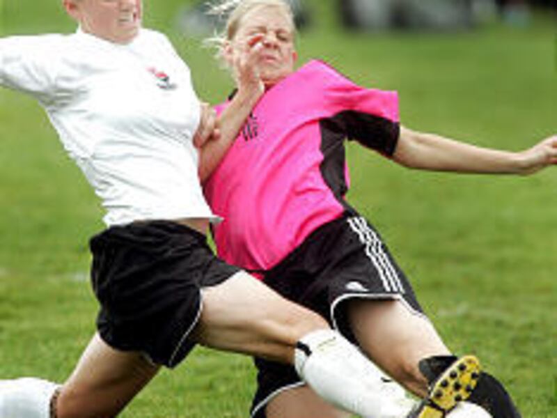 Rebecca Bunnell, left, of the Firebirds and Candice Clark of the Celtic Storm collide at the ball during the girls' U-18 soccer State Cup championship game on Monday.