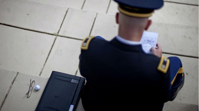 Iraq and Afghanistan war veteran U.S. Army Chaplain Capt. Kevin Peek, looks over his speech before he speaks during a ceremony to commemorate the 11th anniversary of the Sept. 11 terrorist attacks on the campus of Georgia Tech Tuesday, Sept. 11, 2012, in