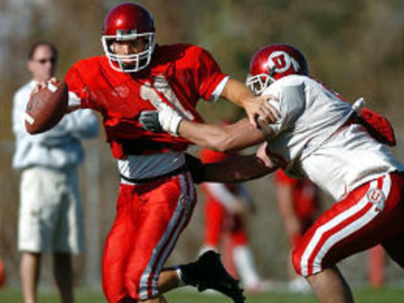 U. quarterback Danny Southwick tries to scramble from Bryce Scanlon during Saturday's practice.