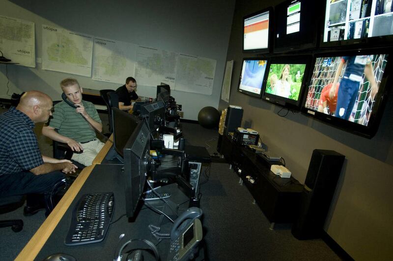 NOC manager Troy Thompson, left, talks with technician Josh Kester in the Utopia network operations center Wednesday, Aug. 1, 2012.