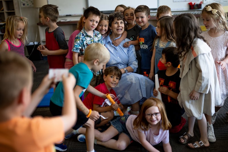Kindergarten students crowd around teacher Louise Bitner on the last day of school at Dilworth Elementary.