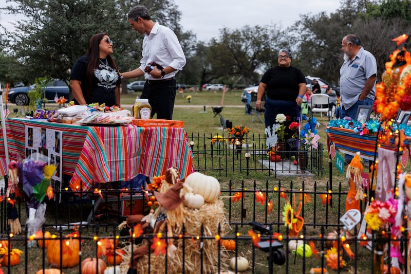 Sandra Cruz Torres chats with Beto O’Rourke as she and her family celebrate Día de los Muertos at Eliahna Torres’ grave in Uvalde, Texas