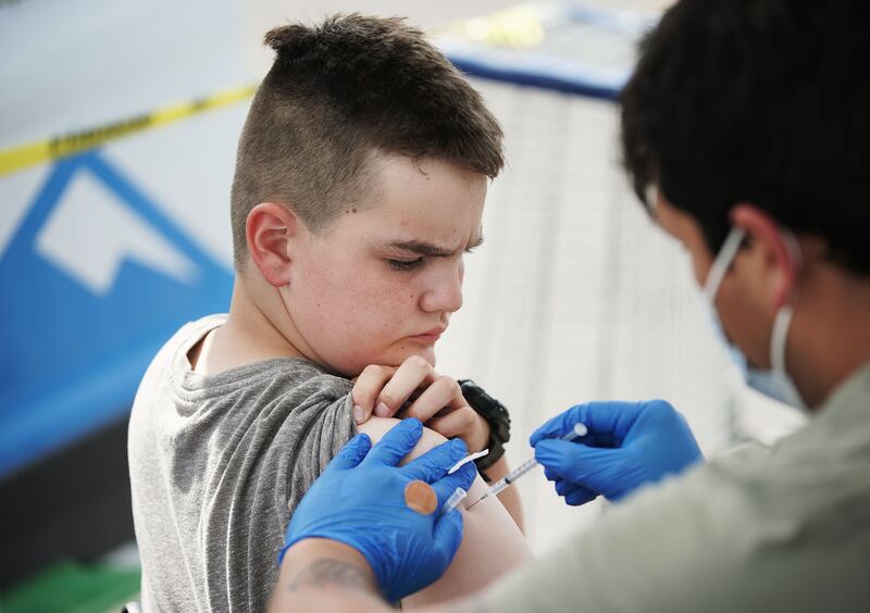 A child receives a COVID-19 vaccination at pop-up clinic sponsored by the Davis County Health Department.
