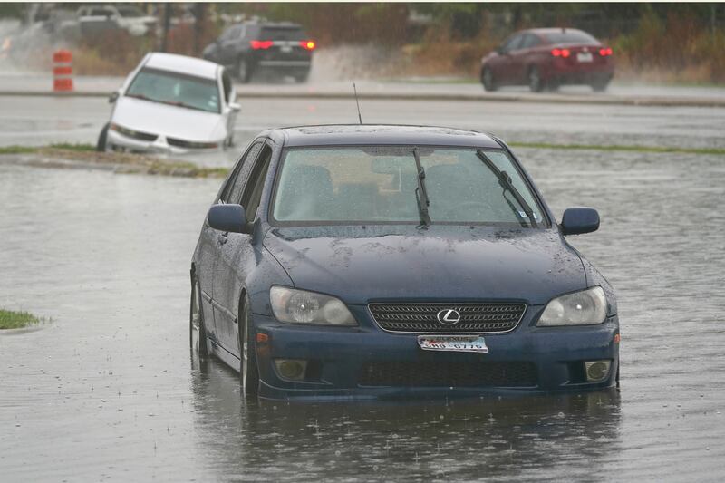 Cars that stalled in high water sit in receding flood waters in Dallas on Monday, Aug. 22, 2022.