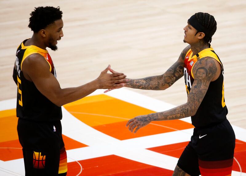 Utah Jazz guard Donovan Mitchell (45) congratulates teammate Jordan Clarkson during a 2021 game.