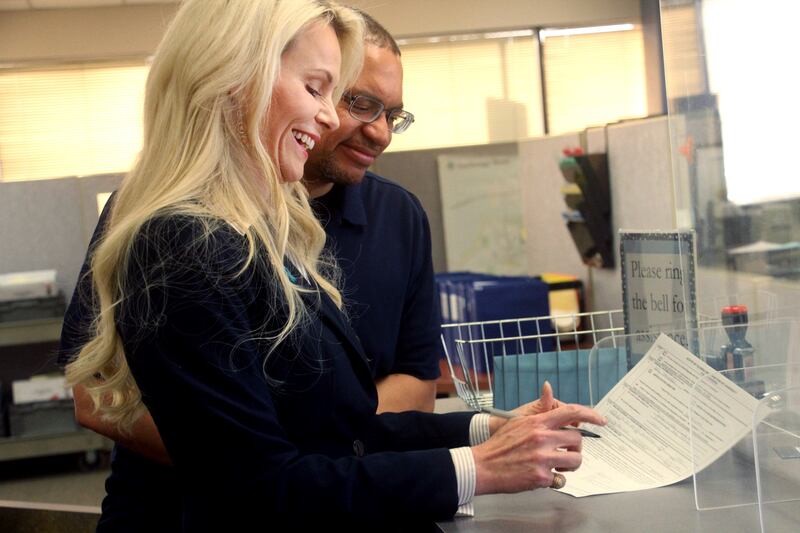 Kelly Tshibaka, left, a Republican, smiles as she officially files to run in Alaska’s U.S. Senate race.