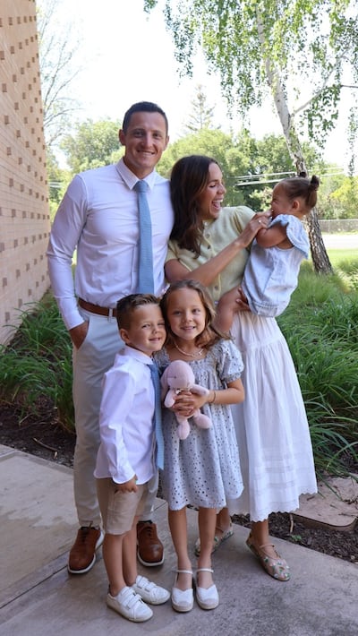 Christian and Ashlee Stewart pose for a picture with their children, Mila, Bo, and baby Goldie.