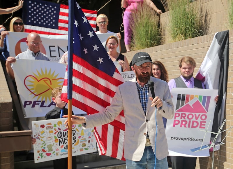 FILE - Utah County Commissioner Nathan Ivie speaks as he holds the American flag during a news conference to discuss the America's Freedom Festival's decision Thursday, June 14, 2018, in Provo, Utah.