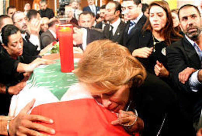 Joyce Gemayel, mother of anti-Syrian Christian politician Pierre Gemayel, mourns at his casket during the huge funeral procession on Thursday in Beirut.