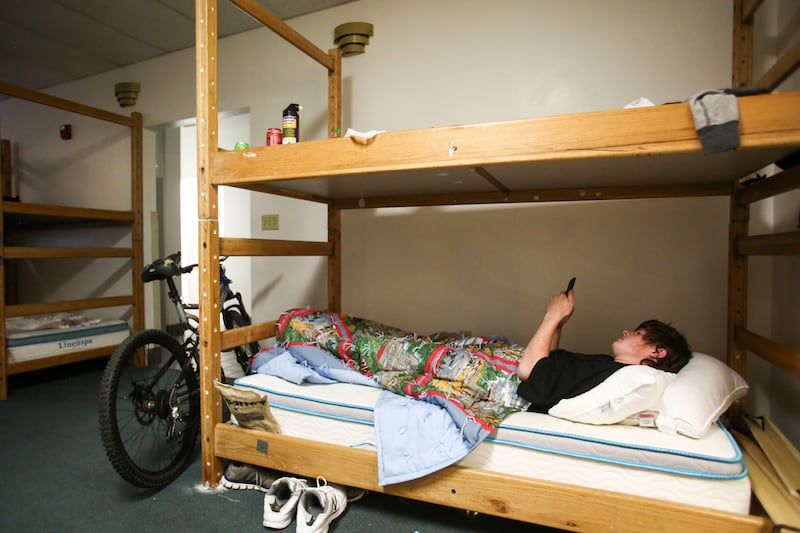Alex Martin relaxes in a bunkbed in a dorm for transient individuals at the Ogden Rescue Mission in Ogden on Friday, May 17, 2019.