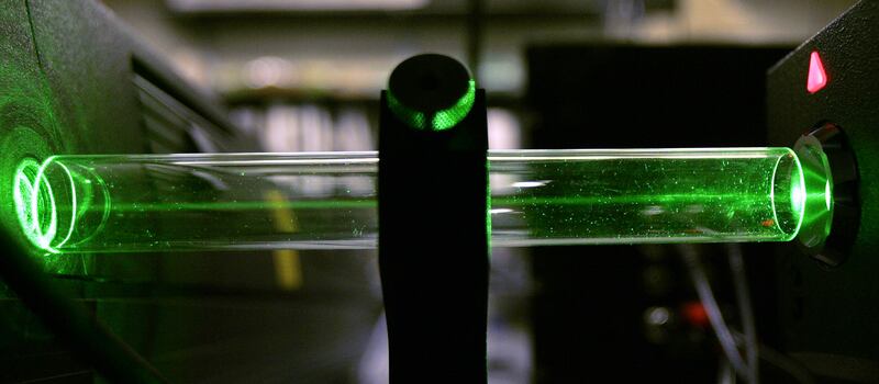 The laser light used in a special camera at the National Technology Center for Networks and Pathways lab is seen going through a glass tube in Pittsburgh on Monday, April 24, 2006