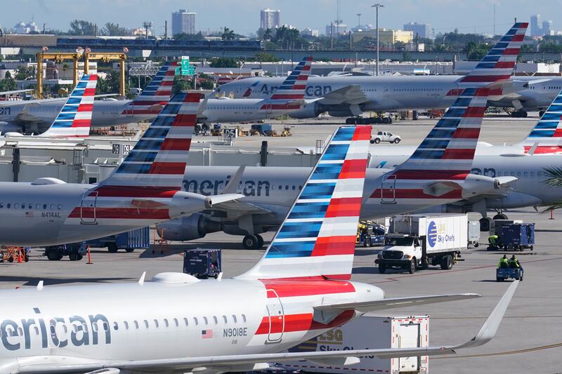 American Airlines planes are parked at Miami International Airport gates. A national pilot shortage has led American Airlines to shut down flights to three different cities.