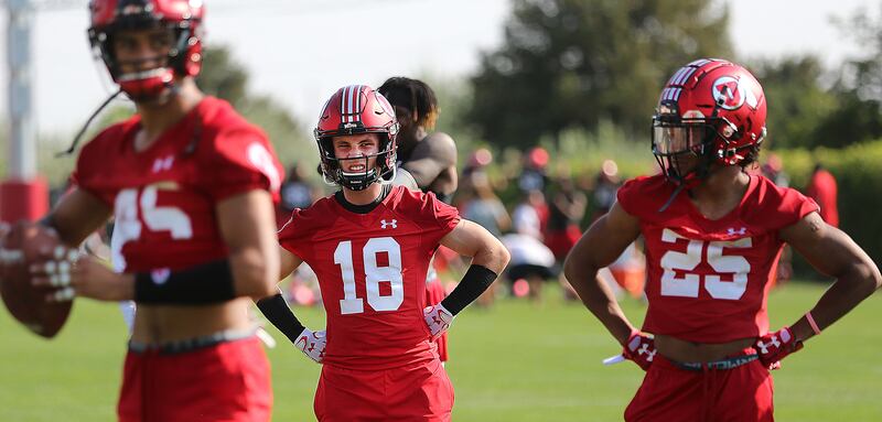 Britain Covey (18) waits with teammates to work on catching drills as the University of Utah opens fall camp in Salt Lake City on Wednesday, Aug. 1, 2018.