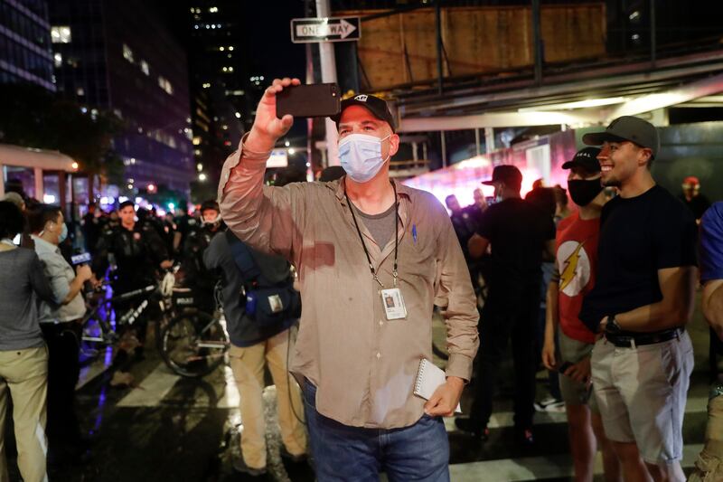 Associated Press NBA reporter Brian Mahoney records video while covering a protest, Wednesday, June 3, 2020, in New York. When the NBA season was suspended and he was reassigned to the news department,heI assumed it was just to report from here. But, according to Mahoney, there were so many coronavirus stories to tell: Health care workers trying to keep patients alive. Residents of a community who all knew somebody who had died. (AP Photo/Seth Wenig)
