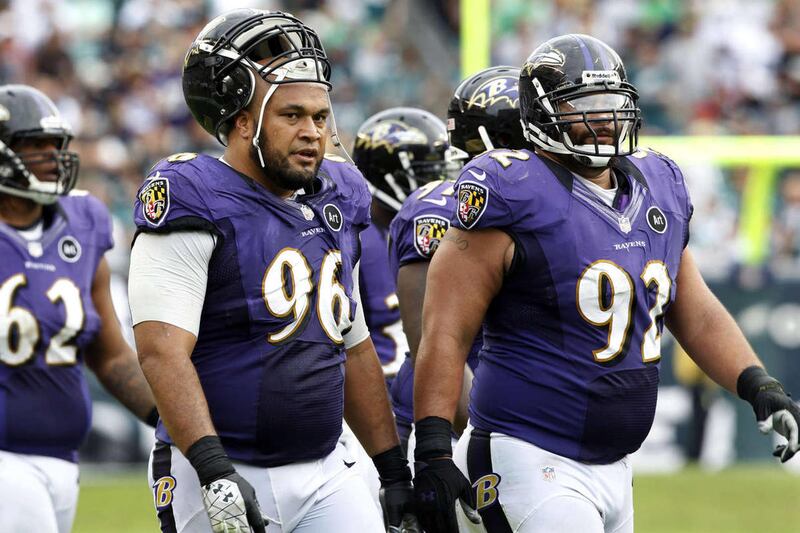 FILE - In this Sept. 16, 2012, file photo, Baltimore Ravens nose tackle Maake Kemoeatu (96) walks with defensive end Haloti Ngata (92) and nose tackle Terrence Cody (62) late in the second half of an NFL football game against the Philadelphia Eagles in Ph
