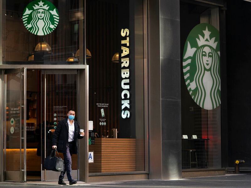 A man walks out of Starbucks in New York.