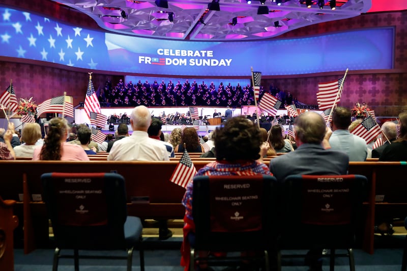 Attendees wave flags as music is played before Vice President Mike Pence made comments at First Baptist Church Dallas, Sunday, June 28, 2020.