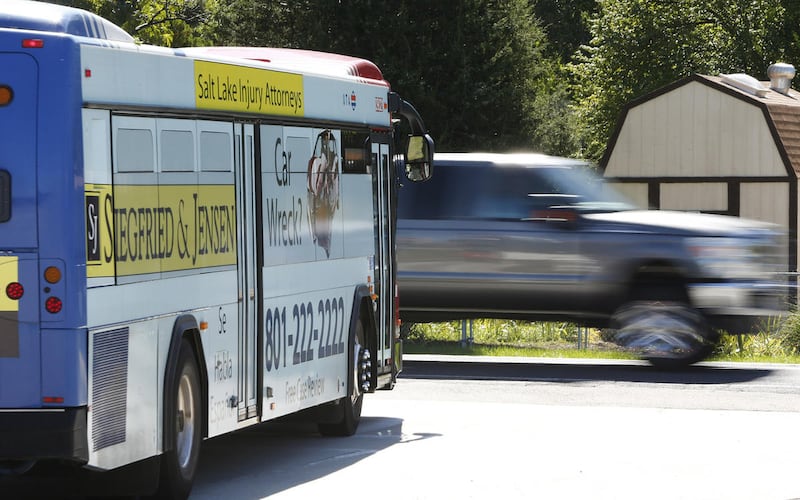 FILE - UTA bus waits for a passing truck in West Valley City Tuesday, Sept. 22, 2015. Love BYU football but hate fighting game-day traffic? The Utah Transit Authority is offering discounted service to and from all BYU football home games at LaVell Edward