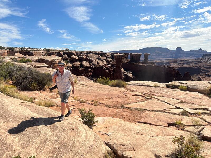 Gary McKellar walks along the White Rim Trail in Moab, Utah.