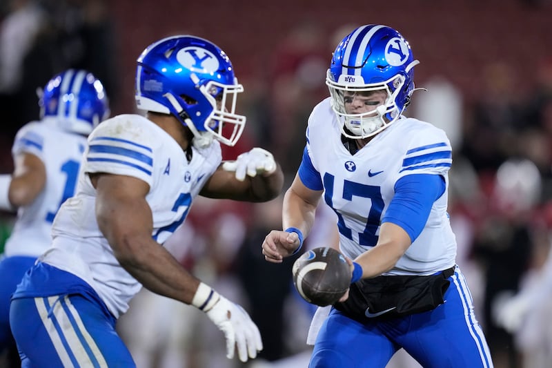 BYU quarterback Jacob Conover hands the ball off to running back Christopher Brooks against Stanford.