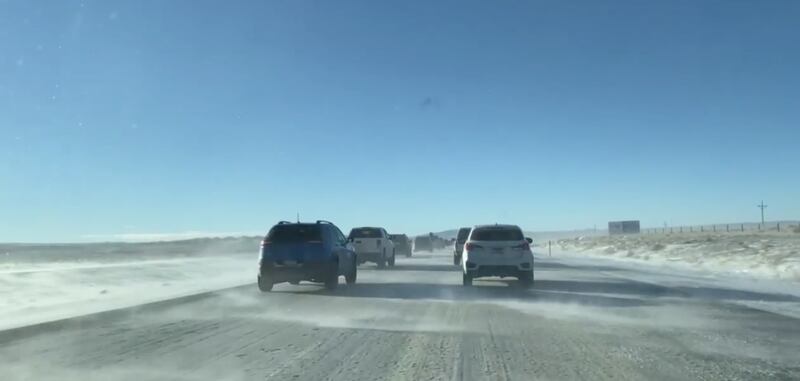 Winds whip across I-80 in Wyoming near mile marker 228, slowing down vehicles and icing up the roads on Sunday Dec. 12, 2021.