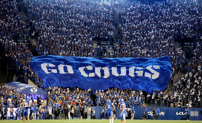 Fans cheer as the Brigham Young Cougars play the Cincinnati Bearcats in a football game at LaVell Edwards Stadium in Provo on Friday, Sept. 29, 2023.