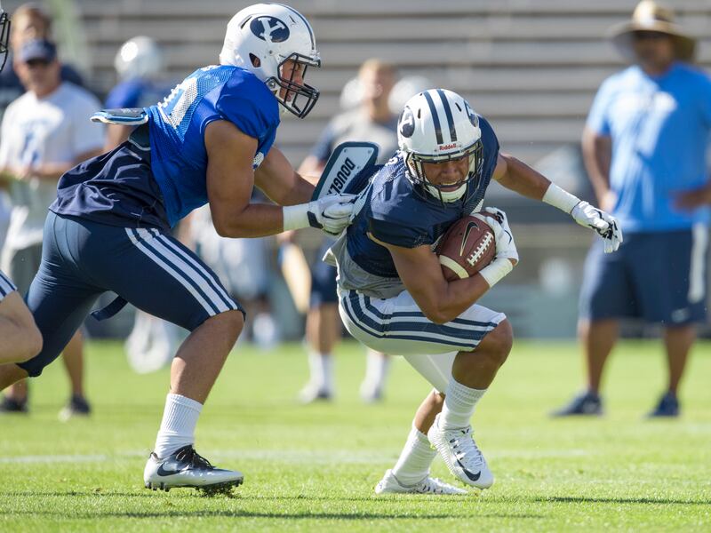 BYU wide receiver Aleva Hifo tries to evade linebacker Kavika Fonua during the team’s scrimmage at LaVell Edwards Stadium on Saturday, Aug. 13, 2016. Hifo will be among those returning kickoffs for the Cougars this fall.