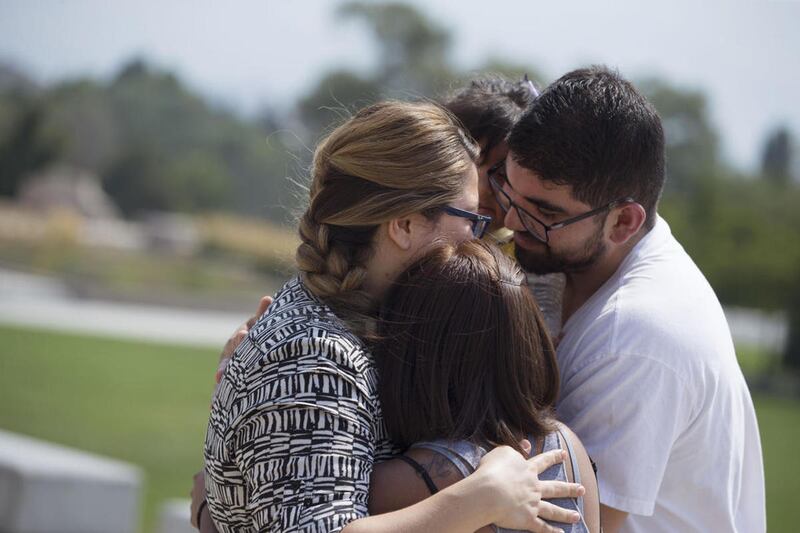 FILE - Karla Mitre, left, hugs her family after attending a gathering of DACA supporters at the Capitol in Salt Lake City on Tuesday, Sept. 5, 2017. President Donald Trump is dismantling the Deferred Action for Childhood Arrivals program. The government p