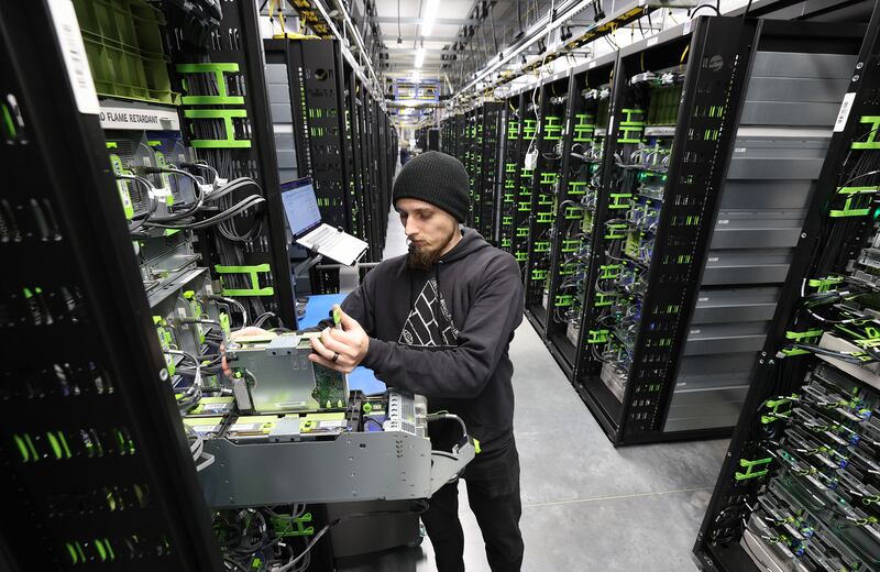 Dylan Poulsen works on a server at Meta’s Eagle Mountain Data Center in Eagle Mountain, Utah.