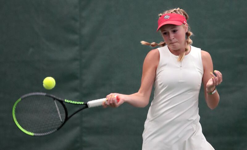 Woods Cross High School’s Sage Bergeson hits a return as she and Highland’s Dylan Lolofie battle for the 5A tennis state championship.