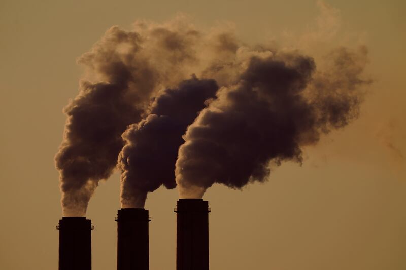 Emissions rise from the smokestacks at the Jeffrey Energy Center coal power plant as the suns sets, near Emmett, Kansas, United States.