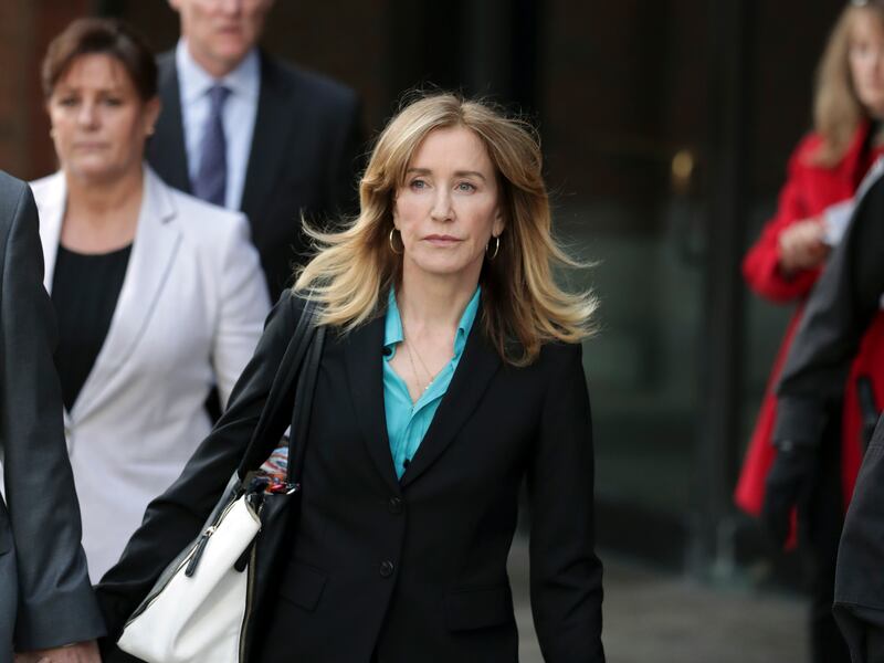 Actress Felicity Huffman departs federal court in Boston on Wednesday, April 3, 2019, after facing charges in a nationwide college admissions bribery scandal. (AP Photos/Charles Krupa)