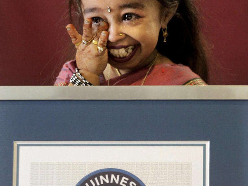 Jyoti Amge wipes her tears after getting the title of the shortest Woman of the world, in Nagpur, India, Friday, Dec. 16, 2011. Amge was declared the shortest woman in the world measuring 62.8 centimeters (24.7 inches) by the Guinness World Records.
