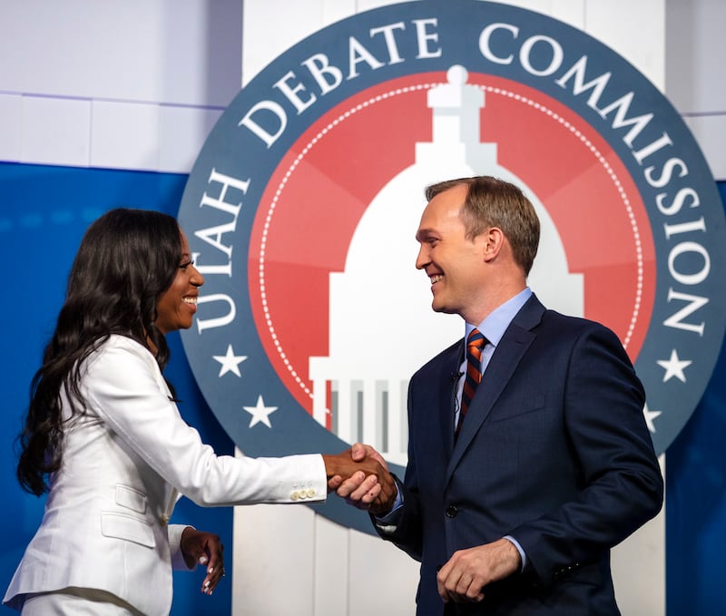 FILE - U.S. Rep. Mia Love and Salt Lake County Mayor Ben McAdams shake hands as they take part in a debate at the Gail Miller Conference Center at Salt Lake Community College on Monday, Oct. 15, 2018, in Sandy, Utah, as the two battle for Utah's 4th Congr