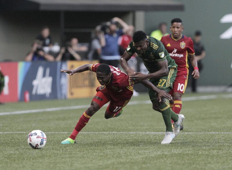 Real Salt Lake's Demar Phillips (17) and Portland Timbers' Dairon Asprilla (27) vie for the ball during an MLS soccer match Wednesday, July 19, 2017, in Portland, Ore. (Sean Meagher/The Oregonian via AP)