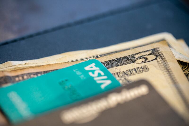 U.S. currency and credit cards sit on a table at a business in New Orleans.